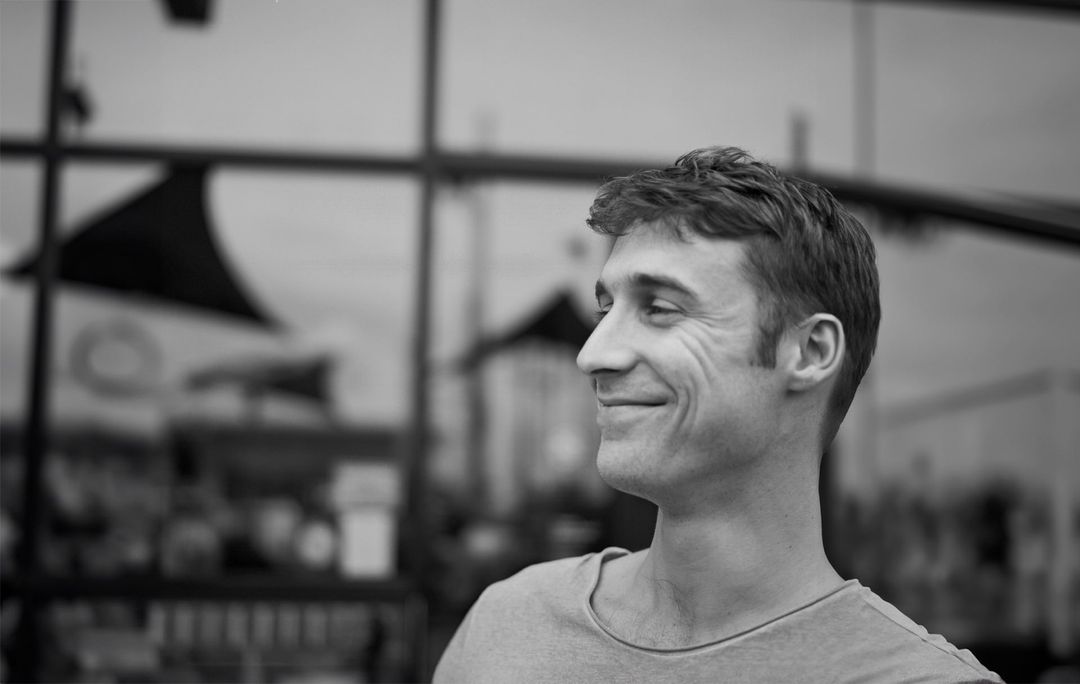 Chris Hayden, smiling, in black and white